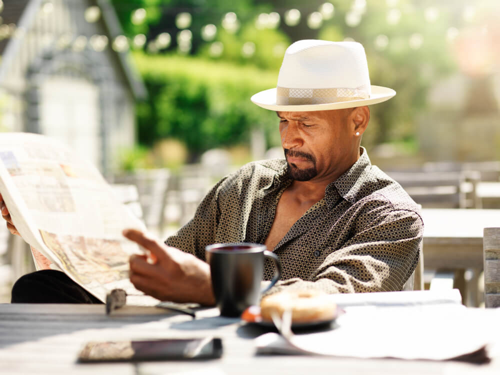 Man in his 40s or 50s reading the newspaper