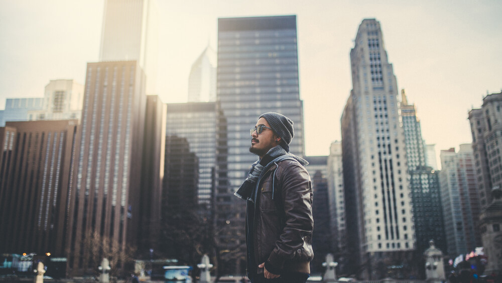 Man in his 30s outside with Chicago skyline behind him